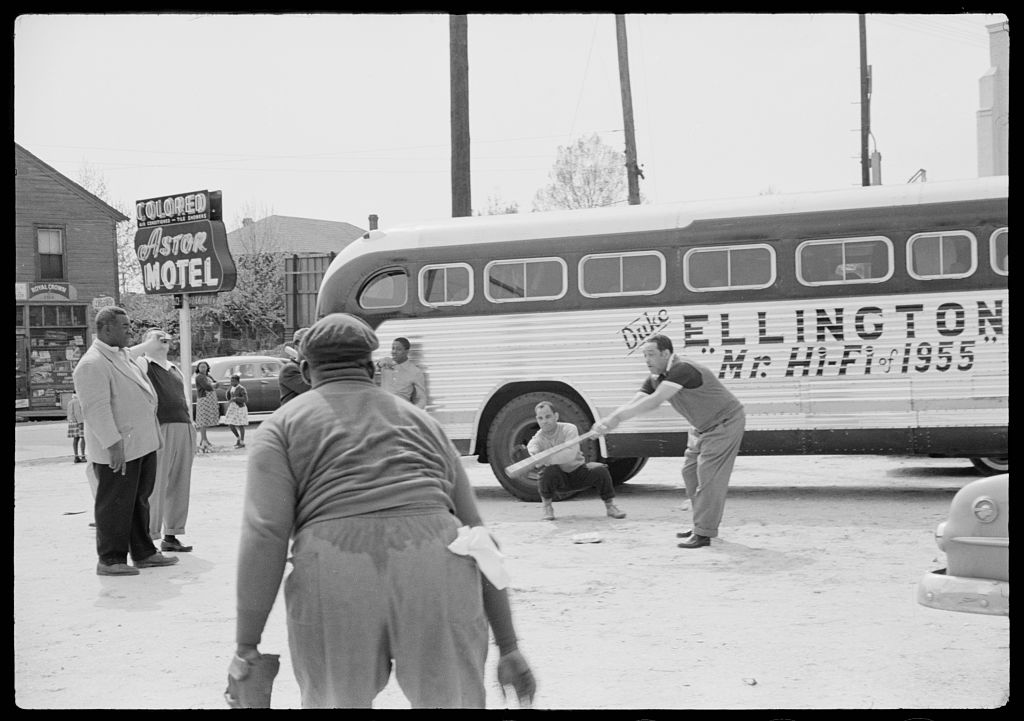 [Duke Ellington and band members playing baseball in front of their segregated motel (Astor Motel) while touring in Florida] by Brooks, Charlotte 1955