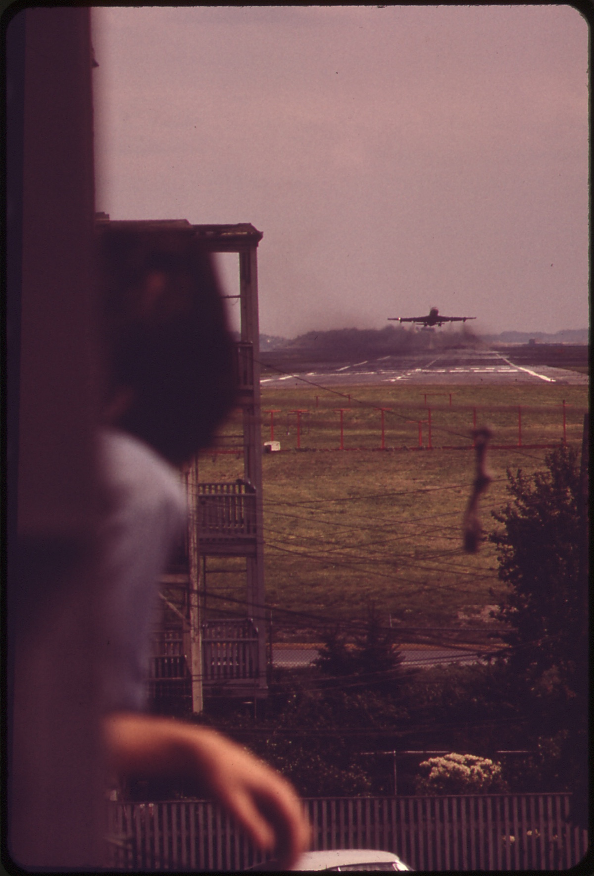  From the Rear Porch of His Home at the Southern Corner of Neptune and Lovell Streets, Larry Vienza Watches Jet Take Off from Runway 15r-33l. Once Airborne, the Jet Will Fly Directly Over His House 05/1973