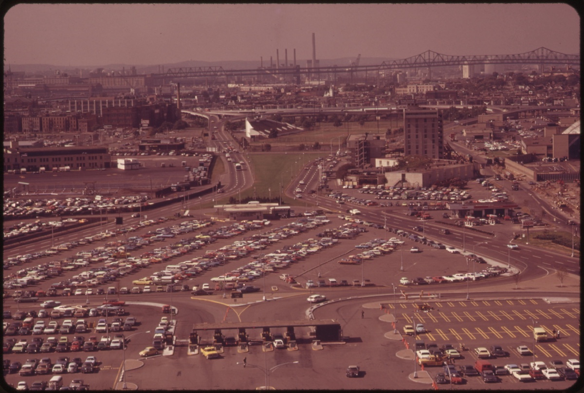 Logan Airport Looking Northeast from 16th Floor Observation Deck. Main Access Road to Airport on the Left. Parking Fields. Main Exit Road on the Right. Tobin Bridge in Background 09/1973