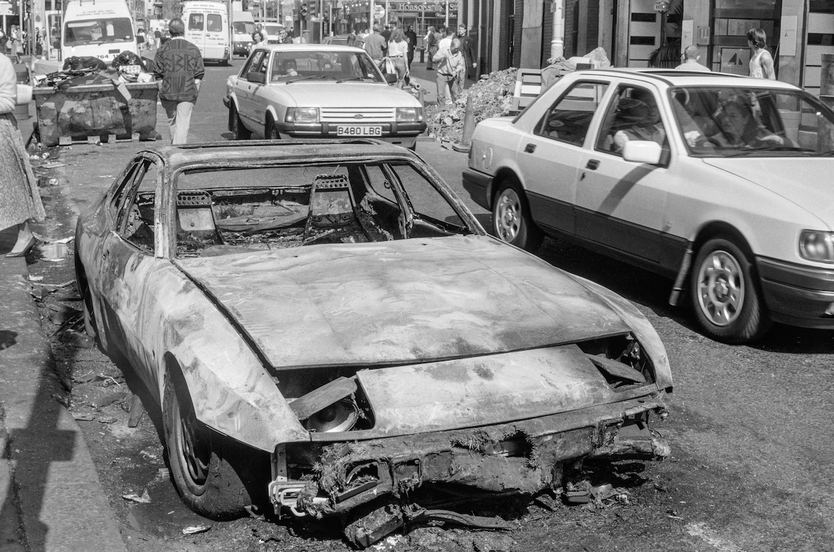 Burnt out car, St Martin's Lane, Covent Garden, Westminster, 1990