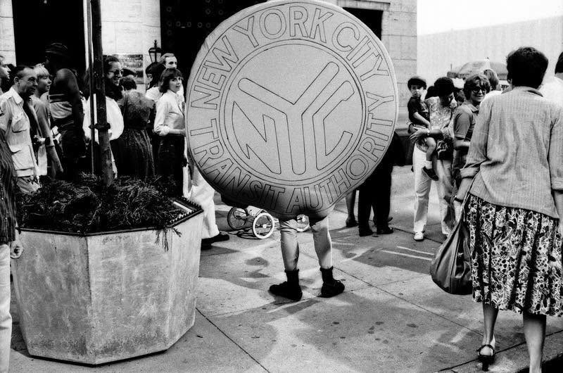 1983. Man dressed as a Subway Token for a MTA promotional event. 20 years later the token would be obsolete with the introduction of the Metro Card. Jeff Rothstein, photog.